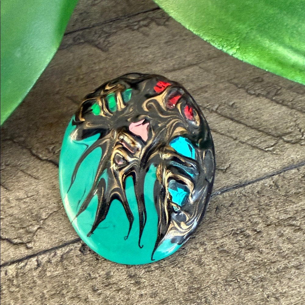 Teal Glass Cabochon with Metallic Black & Red Accents Pin